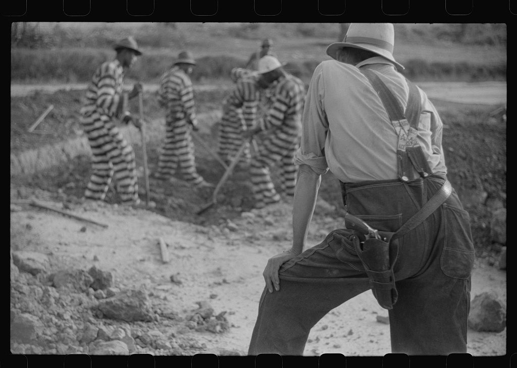 Convicts in striped uniforms working under an armed guard, Oglethorpe County, Georgia, May 1941