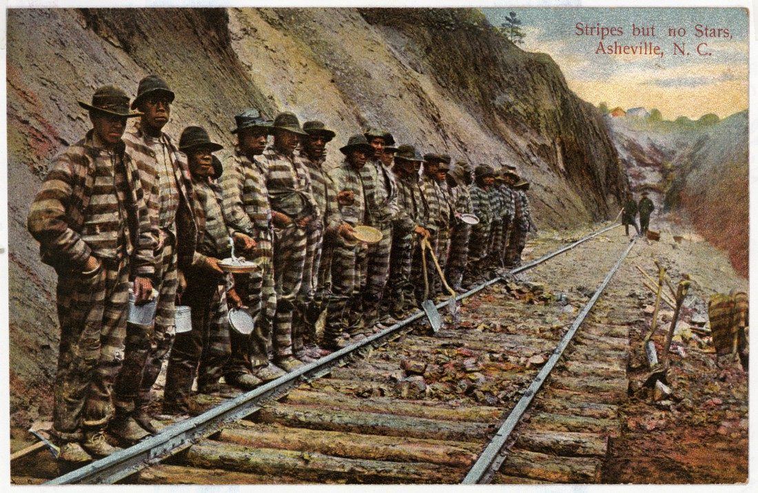 Color postcard of a chain gang in striped uniforms on a railroad cut, Asheville, North Carolina, 1892