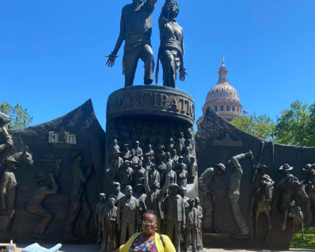 Savannah Eldrige in front of the Texas State Capitol and the New Texas African American Monument