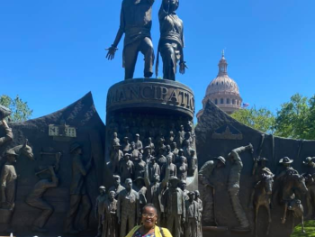 Savannah Eldrige in front of the Texas State Capitol and the New Texas African American Monument